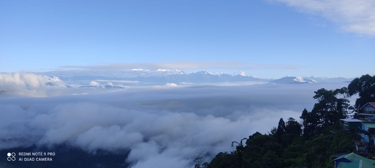 Kanchenjunga snow peaks above the clouds from Sonada